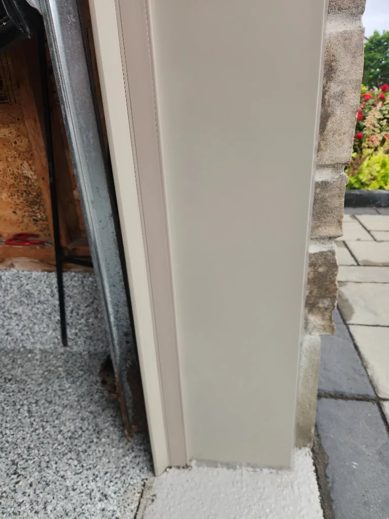 After photo: beige aluminum capping on garage door jamb with new weather seal in Ottawa
