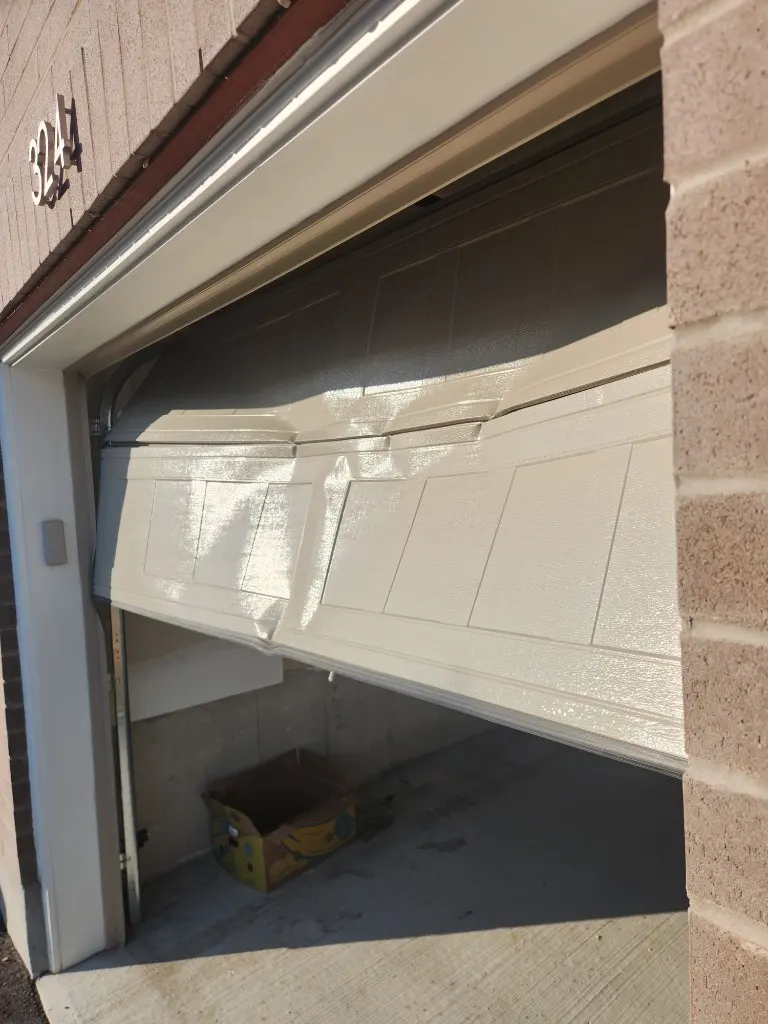 Garage door buckled after impact — emergency repair in Nepean Ontario