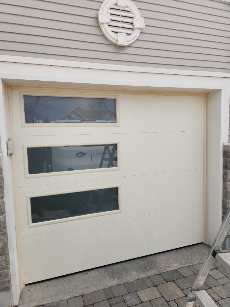 New cream garage door with horizontal windows installed in Barrhaven, Ottawa