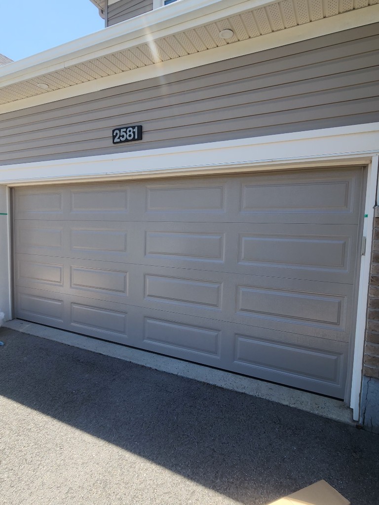 New grey raised-panel garage door installed in Barrhaven Ottawa
