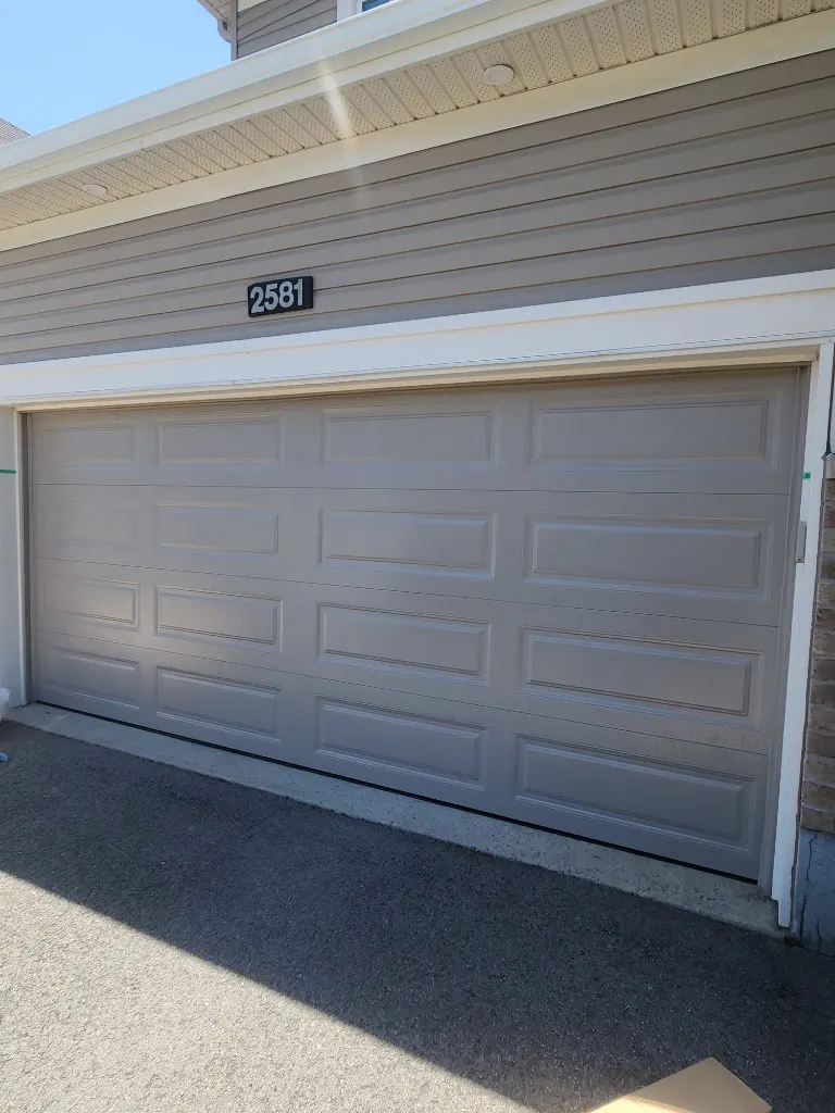 New grey raised-panel garage door installed in Barrhaven, Ottawa