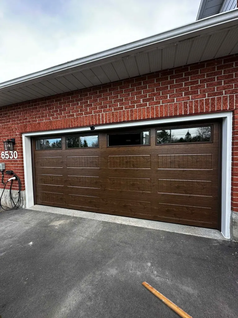 New 16x7 garage door with windows installed in Greely, Ottawa