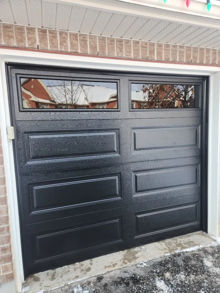 New black garage door with windows installed in Nepean Ontario