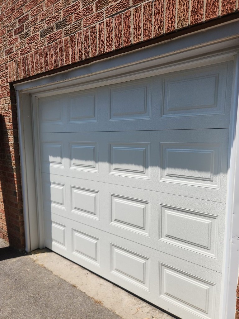 Single garage door replacement on a brick home — North Gower service area