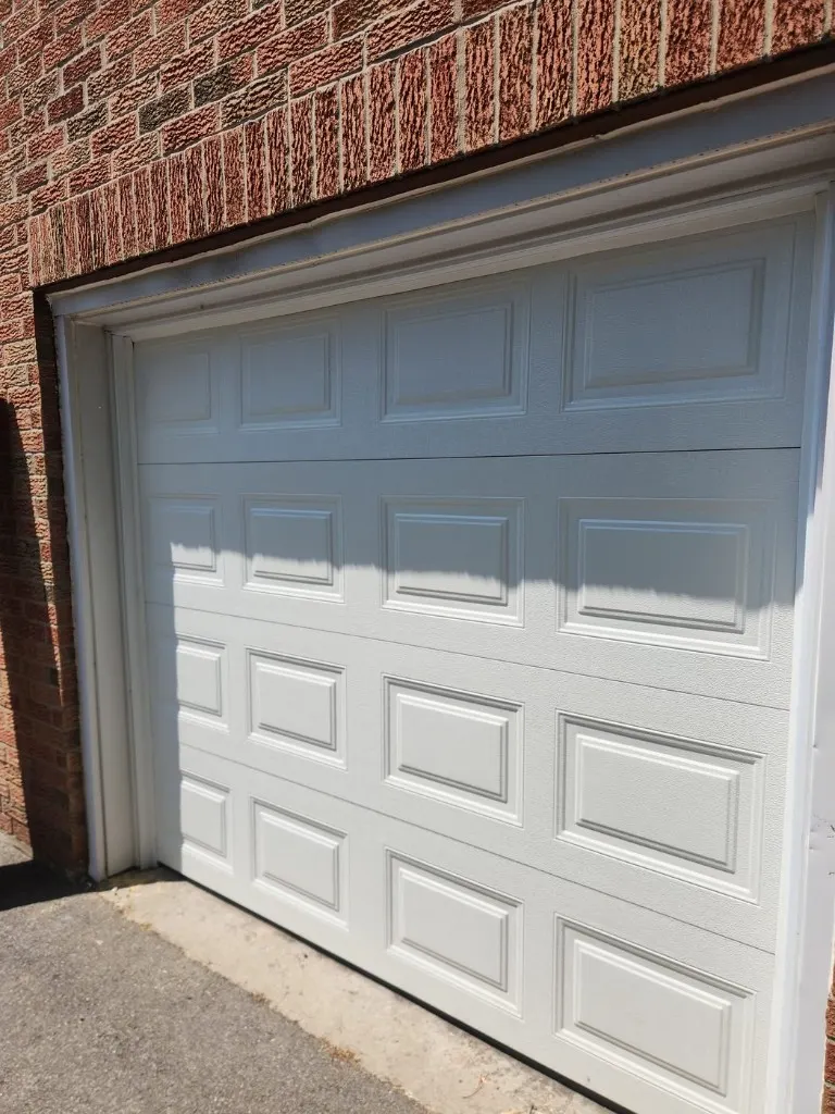 Single garage door replacement on a brick home — North Gower service area