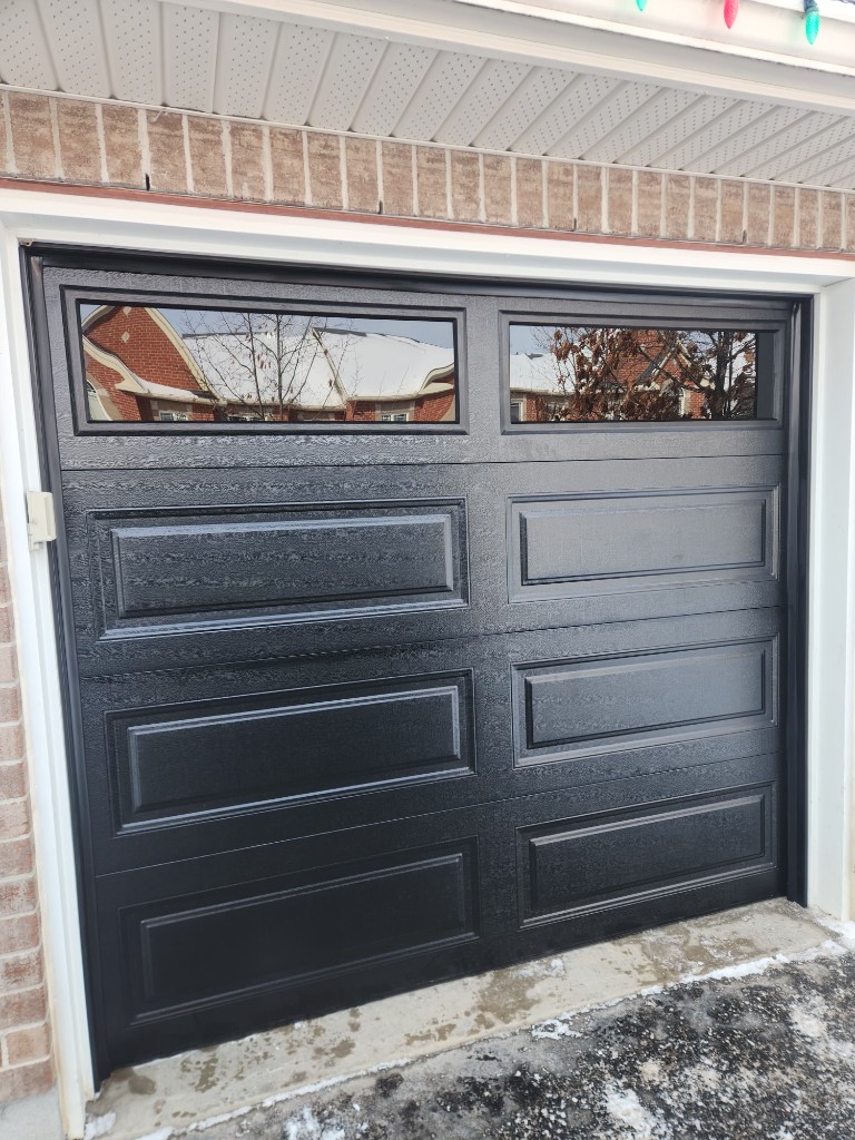 Black garage door installation with top windows in Ottawa