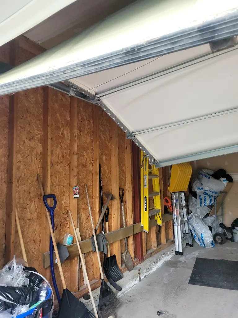 Damaged garage door panels and track repaired from inside a Stittsville Ontario garage
